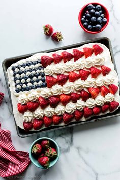 an american flag cake with strawberries and blueberries