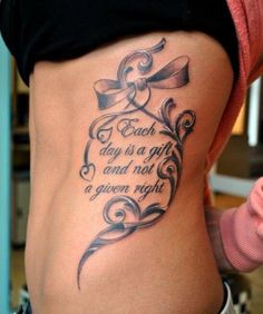 a woman with a tattoo on her stomach saying each day is a gift and not a given right