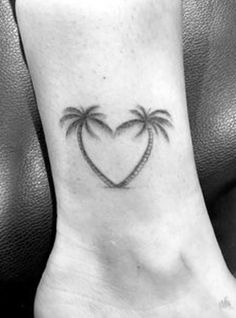 a small heart with two palm trees on the side of the ankle tattoo designs for women