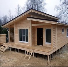 a small wooden house sitting on top of a dirt field