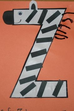 the letter z is made up of zebra's head and stripes on an orange background