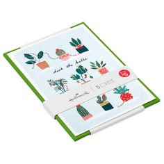 a green and white binder with cactus designs on the front, featuring three different plants