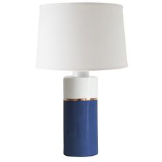 a blue and white table lamp with a white shade on the top, against a white background