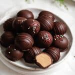 a white bowl filled with chocolate covered candies