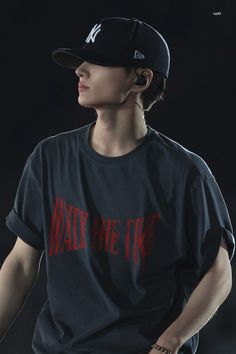 a young man wearing a black hat and t - shirt with the words walk the line on it