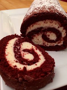 a chocolate roll with white frosting on a plate