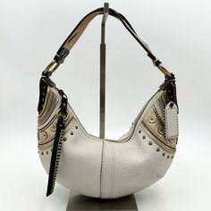 Preowned Great Condition Rare And Hard To Find This Is A Beautiful Coach Soho Hobo Bag In A White Pebbled Leather. Creed # H0669-F10477. Special Mixed Media Stitched Grommet Studs Detailing On Both Sides Braided Leather Strap *Approx* Measurements 12” X 2” X 7” White Leather Bags With Brass Hardware, Boho Y2k, Hobo Bags, Side Braid, Braided Leather, Hobo Bag, Pebbled Leather, Soho, Leather Straps