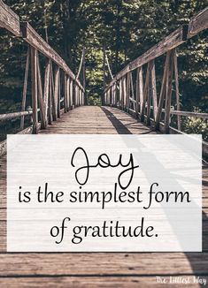 a wooden bridge with the words joy is the simplest form of gratitude