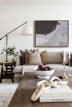 a living room filled with furniture and a white bowl on top of a coffee table