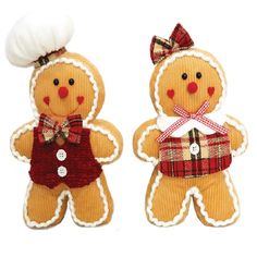 two gingerbread man and woman ornaments on white background