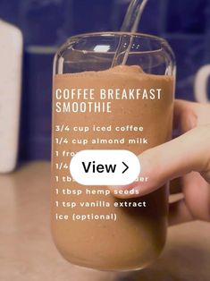 a hand holding a glass with a smoothie in it and the text coffee breakfast smoothie