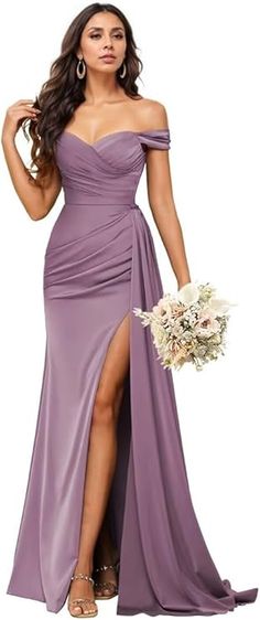 a woman in a long purple dress holding a bouquet and posing for the camera with her legs crossed