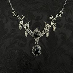 "This enchanting moon elf necklace features richly detailed antiqued silver tone filigree crescent, intricate leafy branches and elegant scroll drop accents. Its captivating design is adorned with dazzling jet black glass crystals. Decorated portion is 4 1/2\" wide and 2 1/2\" tall in the very center.  Necklace length is adjustable with soldered stainless steel cable chain, lobster clasp and extender. If you would like a different length, please send us a message. Matching headpiece, pendant and earrings are listed separately in our store. If you don't see items with a color you want, feel free to ask about availability." Silver Necklace For Fantasy Events, Medieval Style Silver Necklaces For Fantasy Events, Silver Gothic Necklaces For Fantasy Events, Silver Gothic Jewelry For Fantasy Events, Medieval Black Jewelry For Fantasy Events, Elegant Silver Jewelry For Fantasy Events, Fantasy Silver Jewelry With Moon Charm, Silver Bohemian Jewelry For Fantasy Events, Mystical Silver Jewelry With Intricate Design