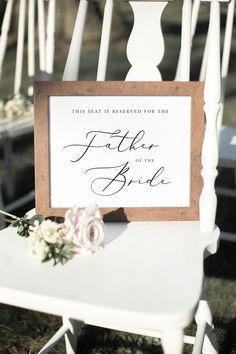 a white chair with a sign that says, this beat is reserved for the father of the bride