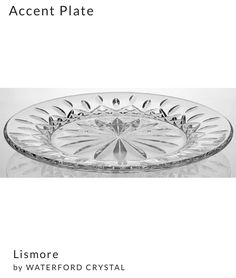 a glass plate sitting on top of a white tablecloth with the words accent plate above it