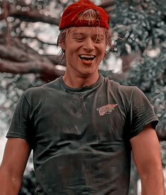 a man wearing a red bandana and smiling