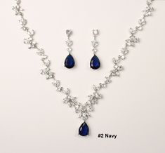 "The default will be: \"Navy Blue CZ Stone, Kraft/Tan box with twine  & no message\". If you need different colored Stone, please check the stone color chart in last photo &  specify the color number in checkout notes section. This three pieces jewelry set is made with high quality AAA cubic zirconia on triple white gold plated set.  The necklace has 15 CZ sections linked with a Teardrop CZ pendant size of 12 x16mm. Total length is 17-19 inches adjustable. Let me know if you would like customized to different length. Bracelet has 6 CZ sections linked to size of 6.5 inch. Extend clasp included to fit wrist size 6.5 ~7.5 inch. if you need custom length, please contact me for detail.  Drop Earring pendant size is 12x16mm, with total length 1.25 inch.  Earring has been triple plated to ensure Blue Necklace And Earring Set, Navy Blue Jewelry Set, Royal Blue Prom Jewelry, Dark Blue Jewelry Set, Jewelry For Navy Blue Dress, Blue Silver Jewelry, Silver And Blue Necklace, Blue Prom Accessories, Silver Blue Jewelry