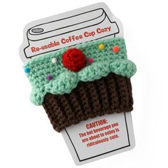 a crocheted cup cozy with a red rose on it's top is shown in front of a white background