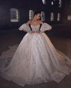 a woman in a wedding dress is posing for the camera with her hands on her hips