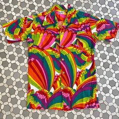 Vintage 70s rainbow Hawaiian men's button down shirt in excellent condition. Chest 40 length 27.5 shoulder 17 For first dibs on more colorful vintage goods and groovy 70s clothes, check out my Instagram @magicbusvintage. 1970s 60s 1960s hippie groovy colorful patchwork rainbow crazy grail top blouse shirt button up long sleeved Retro Summer Shirt With Colorful Pattern, Retro Shirt With Colorful Pattern For Summer, Colorful Vintage Summer Shirt, Retro Shirt With Vibrant Spring Print, Multicolor Collared Shirt With Vibrant Print, Retro Multicolor Hawaiian Shirt For Spring, Multicolor Retro Print Cotton Hawaiian Shirt, Multicolor Cotton Hawaiian Shirt With Retro Print, Retro Multicolor Short Sleeve Shirt