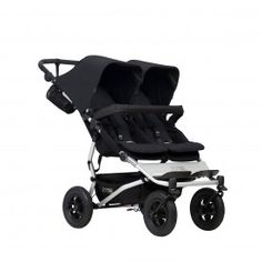 the buggy stroller has four seats and is black with white trim on it