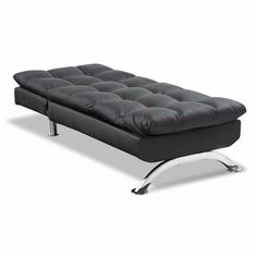 a black futon sofa with chrome legs and footrests on an isolated white background