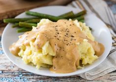 mashed potatoes with gravy and asparagus on a plate