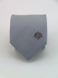 "Mens 100% sill silver on silver necktie. Available as a extra long tie. Handmade from 100% silk, this special collection features a .75\" Eds Neckties logo at the bottom right front corner of every tie and a larger logo located on the tipping (Back of the tie). The label features the collection name (Nathaniel Alexandria) Named after my son Nathaniel and my daughter Alexandria. Expertly hand-made from 100% silk you can select your length from 57\" to 63\" (Great for taller Men). Width is standa Elegant Formal Ties For Father's Day, Silver Tie For Father's Day Formal Wear, Silver Tie For Formal Occasions, Silver Tie For Formal Occasions And Father's Day, Gray Standard Tie For Formal Occasions, Elegant Gray Business Tie, Silver Suit And Tie Accessories For Formal Occasions, Classic Neckwear For Gifts, Silver Standard Tie For Black Tie Events