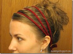 a woman with her hair in a bun is wearing red headbands and looking off to the side