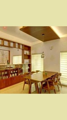 an empty dining room with wooden chairs and a long table in the middle of it