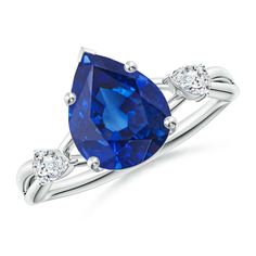 a blue sapphire and diamond ring with three diamonds on the band, set in white gold