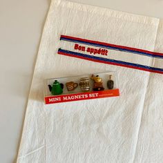 two napkins with magnets on them sitting next to each other