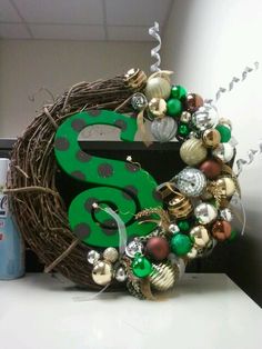 a wreath with the number six on it and ornaments hanging from it's side