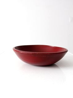 a red bowl sitting on top of a white counter