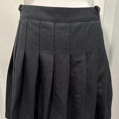 Uo Urban Outfitters Black Pleated Mini Skirt Side Zipper Nwt Size Small This Is Literally The Perfect "Little Black Skirt"!! This Adorable Skirt Is Brand New With Tags - Never Worn - The Pleats Do Need A Little Ironing If You Like Perfect Pleats!! The Skirt Is In Excellent Condition - Side Zipper And 2 Small Belt Loops On Either Side. Skirt Is A Size Small - Waist Measures 26" And From Waist To Hem The Length Is 15". 66% Polyester, 32% Viscose, 2% Elasthanne -- Machine Washable But Line Dry!! High Waist Pleated Skort For School, High Waist Pleated School Skort, School Mini Skirt Solid Color With Lined Skirt, School Mini Skirt Solid Color Lined, Solid Mini Skirt For School, High Waist School Uniform Mini Skirt, Solid Color Lined Mini Skirt For School, Black Mini Skirt For School Uniform, Black Pleated School Uniform Mini Skirt