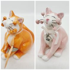 two ceramic figurines of cats sitting next to each other