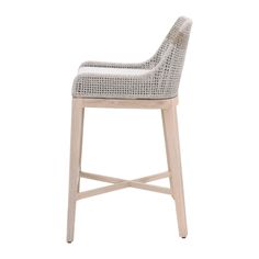 an upholstered wooden stool with white wicker on the seat and backrest