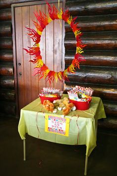 a table with some food on it in front of a door and log wall behind it