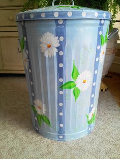 a painted flower pot sitting on the floor