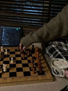 a person playing chess on a laptop computer