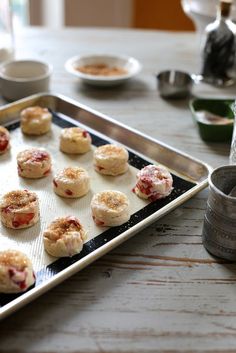 small pastries are sitting on a baking sheet and ready to be baked in the oven