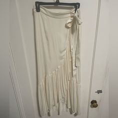 I Purchased This Silky Midi Skirt On A Recent Trip To Paris Only To Come Home And Realize It’s A Bit Small. Brand New Condition. Size 38 In France But A Size 6 Us. Has The Appearance Of A Wrap Skirt But Is Actually Closed Via A Zipper. Lined. White Fitted Ruffled Maxi Skirt, Cream Ruffled Long Skirt, Cream Long Ruffled Skirt, Chic Cream Maxi Skirt With Ruffles, Chic Cream Ruffled Maxi Skirt, Cream Midi Skirt For Day Out, White Flared Wrap Skirt For Summer, Cream Asymmetrical Relaxed Skirt, White Fitted Wrap Skirt For Spring