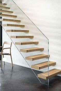 an empty chair sitting in front of a stair case