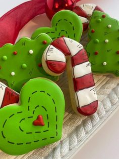 some cookies are sitting on a tray with candy canes in the shape of hearts