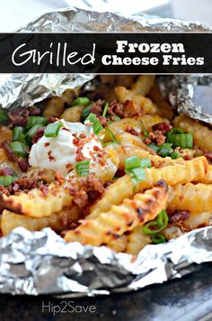 grilled frozen cheese fries with bacon and sour cream on top in foil wrapper