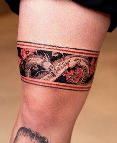 a woman's leg with a tattoo on it and an image of a dragon