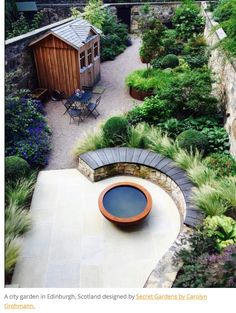 an aerial view of a garden with stone walls and seating area in the foreground