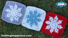 three crocheted snowflakes are laying on the grass