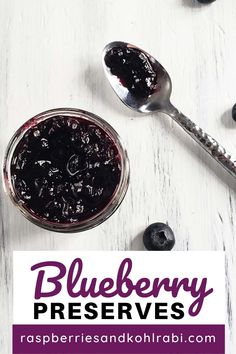 blueberry preserves in a glass jar with spoons