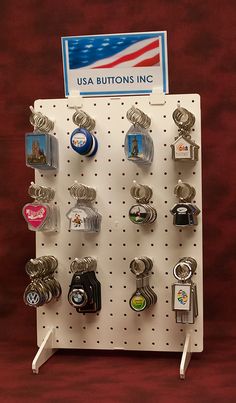 a rack with many different types of buttons and magnets hanging on it's side